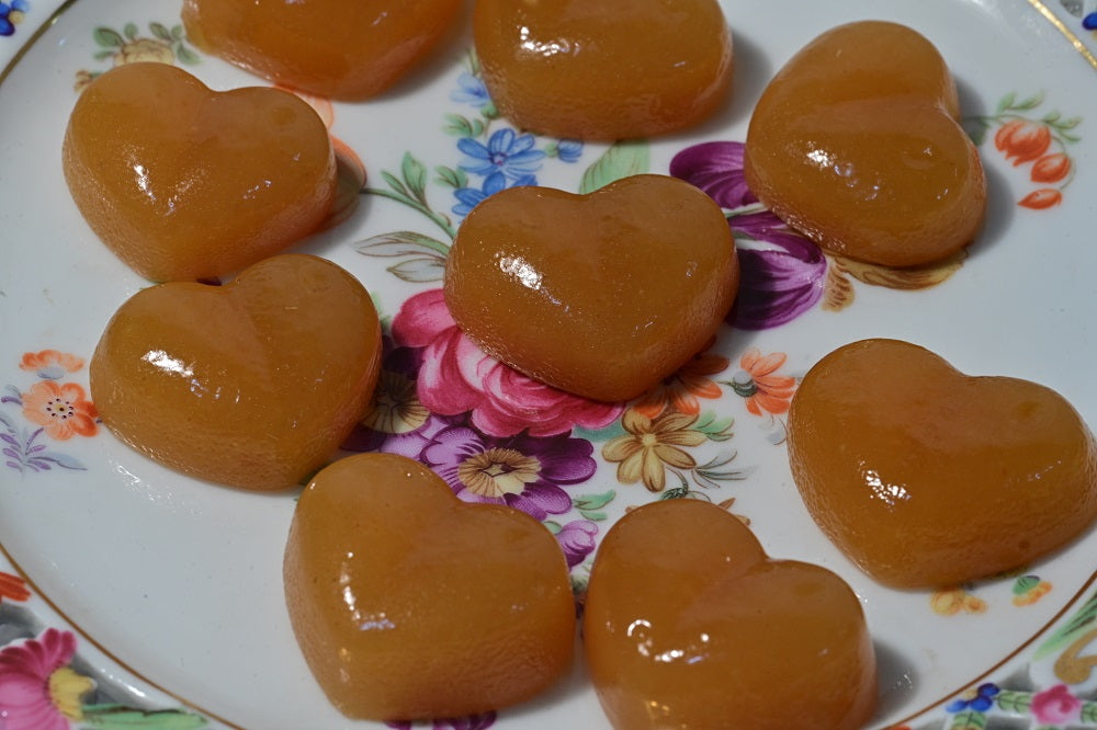 floral plate holding unwrapped ginger caramels.